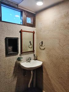 a bathroom with a sink and a mirror at Hotel Rangoli in Jaipur