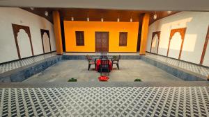 an empty room with two chairs and a table at Shinde's Tikona Valley Farm in Pune