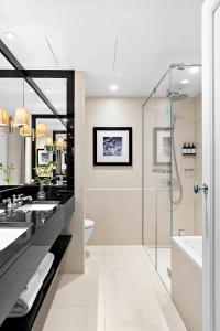 a bathroom with two sinks and a shower at Hotel Continental in Oslo