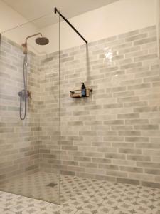 a shower with a glass door in a bathroom at Bonita casa blanca en el bosque. in Córdoba