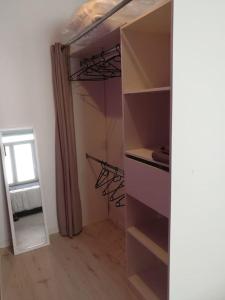 a walk in closet with a door open and a window at Cocoon Bugiste : travail, sport ou détente in Hauteville-Lompnes