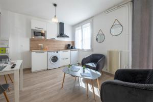 a kitchen and living room with a table and chairs at Dolmen Adrien 5 in Tours