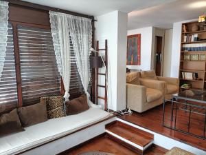 a living room with a couch and a window at Junto a Vielha Apartamento Gausac in Gausach
