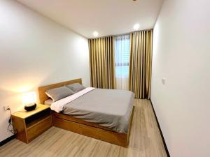 a small bedroom with a bed and a window at C Sky View: 2 BR Apartment Free GYM & POOL in Thu Dau Mot