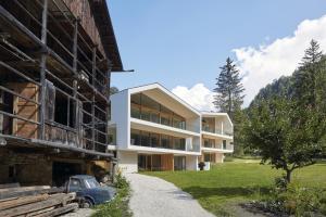 an old car is parked next to a building at Greva Apartments 1 in Santa Cristina in Val Gardena