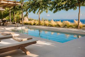 a swimming pool with a chaise lounge next to a swimming pool at Spathes Suite Kefalonia, Romantic Private Escape with Infinity Pool & Sea Views in Ratzaklíon