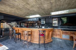 a bar in a restaurant with stools at Le Champ d'Avoine - Saint-Malo - St Servan in Saint Malo
