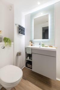 a bathroom with a white toilet and a sink at Cosy Ensuites with Shared Kitchen and Living Area at Alma Place in the heart of Belfast in Belfast