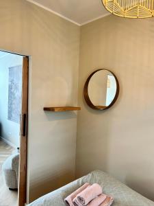 a bedroom with a mirror and a bed at Amsterdam Beach Apartment 33, Private Garden in Zandvoort