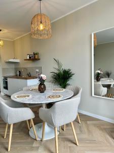 a kitchen and dining room with a table and chairs at Amsterdam Beach Apartment 33, Private Garden in Zandvoort