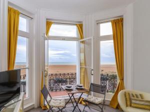 a living room with a view of the beach at The Old Spy Headquarters in Folkestone