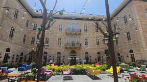 a building with chairs and tables in front of it at Grand Kadri Hotel - History Marked by Cristal Lebanon in Zahlé