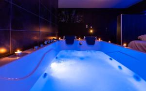 a bath tub in a room with lights at Suite Boréale 50m2 spa privatif. in Nancy