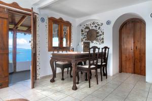 a dining room with a wooden table and chairs at Azul Boutique Home in Skiathos Town