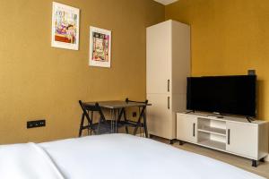 a bedroom with a bed and a tv and a table at Studio Room 6 min to Yedikule Fortress in Fatih in Istanbul