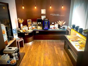 a store with a counter in a store with food at Kyriad Grenoble Centre in Grenoble +16 photos