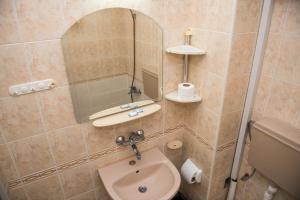 a bathroom with a sink and a mirror at Стаи за гости in Varna City +23 photos