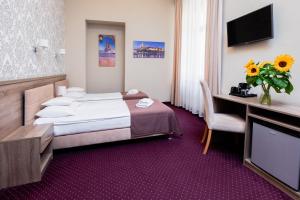 Posteľ alebo postele v izbe v ubytovaní Hotel Maximum