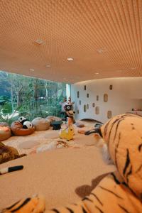 a room with stuffed animals on a bed with a window at NH Hua Hin in Hua Hin