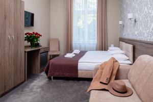 Posteľ alebo postele v izbe v ubytovaní Hotel Maximum