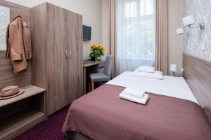 Posteľ alebo postele v izbe v ubytovaní Hotel Maximum