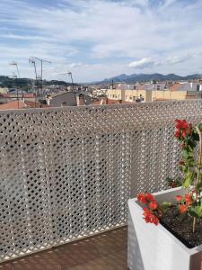 a balcony with a white fence with flowers on it at Bonito Ático in Terrassa