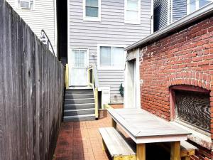 a brick building with a bench next to a brick wall at Two DC Rowhouses Large Groups Sleeps 21 in Washington, D.C.