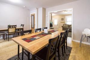 a dining room and living room with a table and chairs at Two DC Rowhouses Large Groups Sleeps 21 in Washington, D.C.
