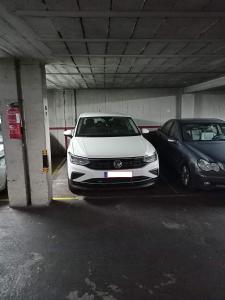 two cars are parked in a parking garage at Alojamientos Villarias Murcia in Murcia