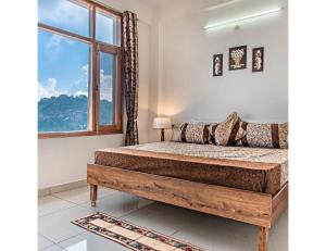 a bedroom with a bed with a large window at Hills View Paradise ,Shimla in Shimla