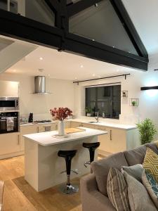 a kitchen with a large white island in a living room at Reading City Centre - Business - Relocation - Luxury Apartment in Reading