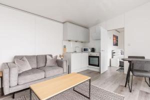 a living room with a couch and a table at Upper Cliff Studio in Portland