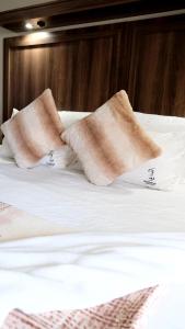a bed with two pillows on top of it at Sedibeng Guest House in Vereeniging