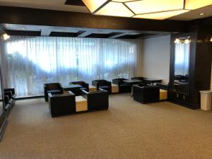 a conference room with black chairs and a large window at ホテル28広島 in Hijiyamachō