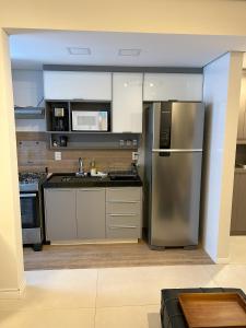a kitchen with a stainless steel refrigerator and a sink at Requinte e Conforto OP - MG in Ouro Preto