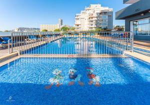 two people in a swimming pool on a building at Port Europa in Calpe
