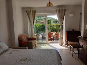 a bedroom with a bed and a view of a patio at La Casa degli Ulivi in Chiavari