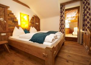 a bedroom with a large bed with white sheets at GMS Holidays in Katschberghöhe