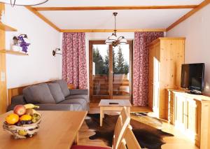 a living room with a couch and a table at GMS Holidays in Katschberghöhe
