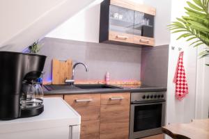 a kitchen with a sink and a stove at #413 Gemütliche Wohnung mitten im Ruhrpott in Mülheim an der Ruhr