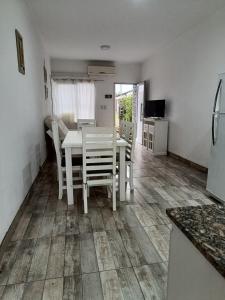 a kitchen with a white table and chairs in a room at CATA 1. SAN JOSE ENTRE RIOS in San José