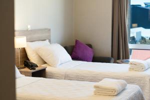 Habitación de hotel con 2 camas y ventana en Lagos Andinos en San Carlos de Bariloche