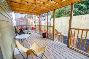 Una terraza de madera con una mesa y sillas. en The Pittsburgh Hideaway-Amazing View-3 Bedrooms, en Pittsburgh