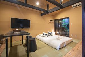 a bedroom with a bed and a desk and a tv at Kyoto - House - Vacation STAY 13904 in Kyoto