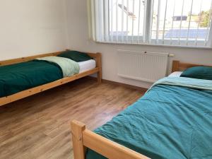 a bedroom with two bunk beds and a window at Woning met 4 slaapkamers in Zelzate