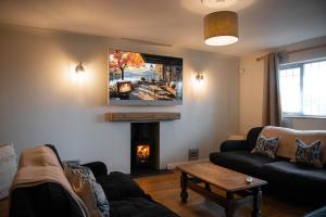 a living room with a couch and a fire place at Cameo Cottage 