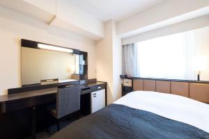 Postel nebo postele na pokoji v ubytování APA Hotel TKP Nippori Ekimae