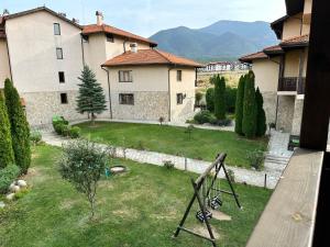 a view from a window of a yard with a house at Top Lodge twobedroom apartment in Bansko
