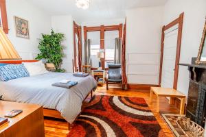 a bedroom with a bed and a fireplace at Step Back in Time Charming Victorian with Modern Amenities in Homestead