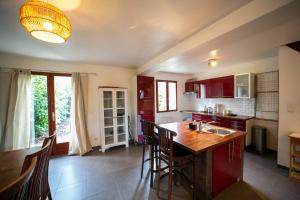 a kitchen with a kitchen island in a room at Milly's House - Charming & Cosy in Milly-la-Forêt